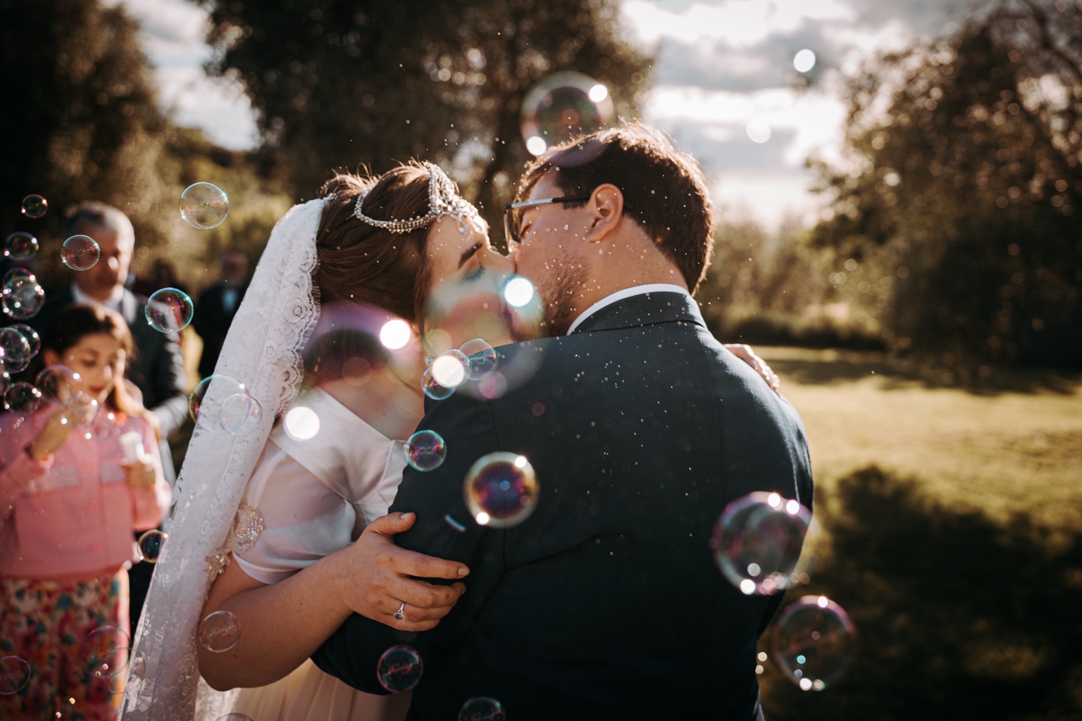 Bacio degli sposi con bolle, reportage matrimonio Toscana
